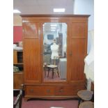 An Early XX Century Satinwood Triple Wardrobe, with stepped pediment, central mirror door flanked by