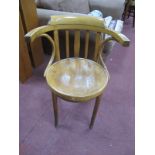An Early XX Century Ash Bentwood Elbow Chair, with a low back rail supports, circular seats.