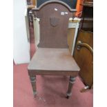A XIX Century Oak Hall Chair, with an arched back, applied shield, solid seat on turned forefront