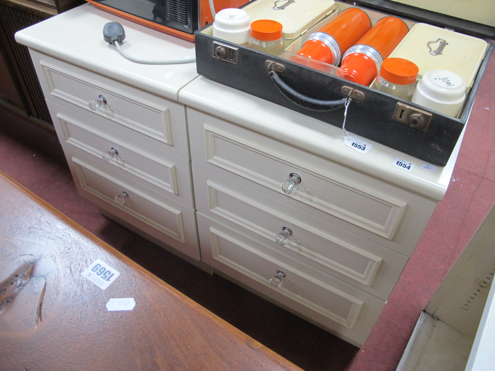 A Pair of Cream Three Drawer Chests, having glass handles, 50cm wide.