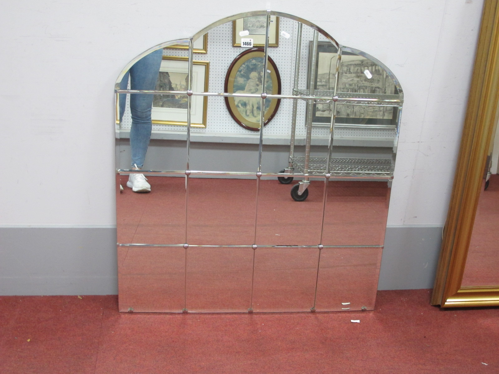 A Mid XX Century Art Deco Sixteen Pane Mirror, 92cm high, 81cm wide, with arched top.