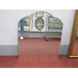 A Mid XX Century Art Deco Sixteen Pane Mirror, 92cm high, 81cm wide, with arched top.