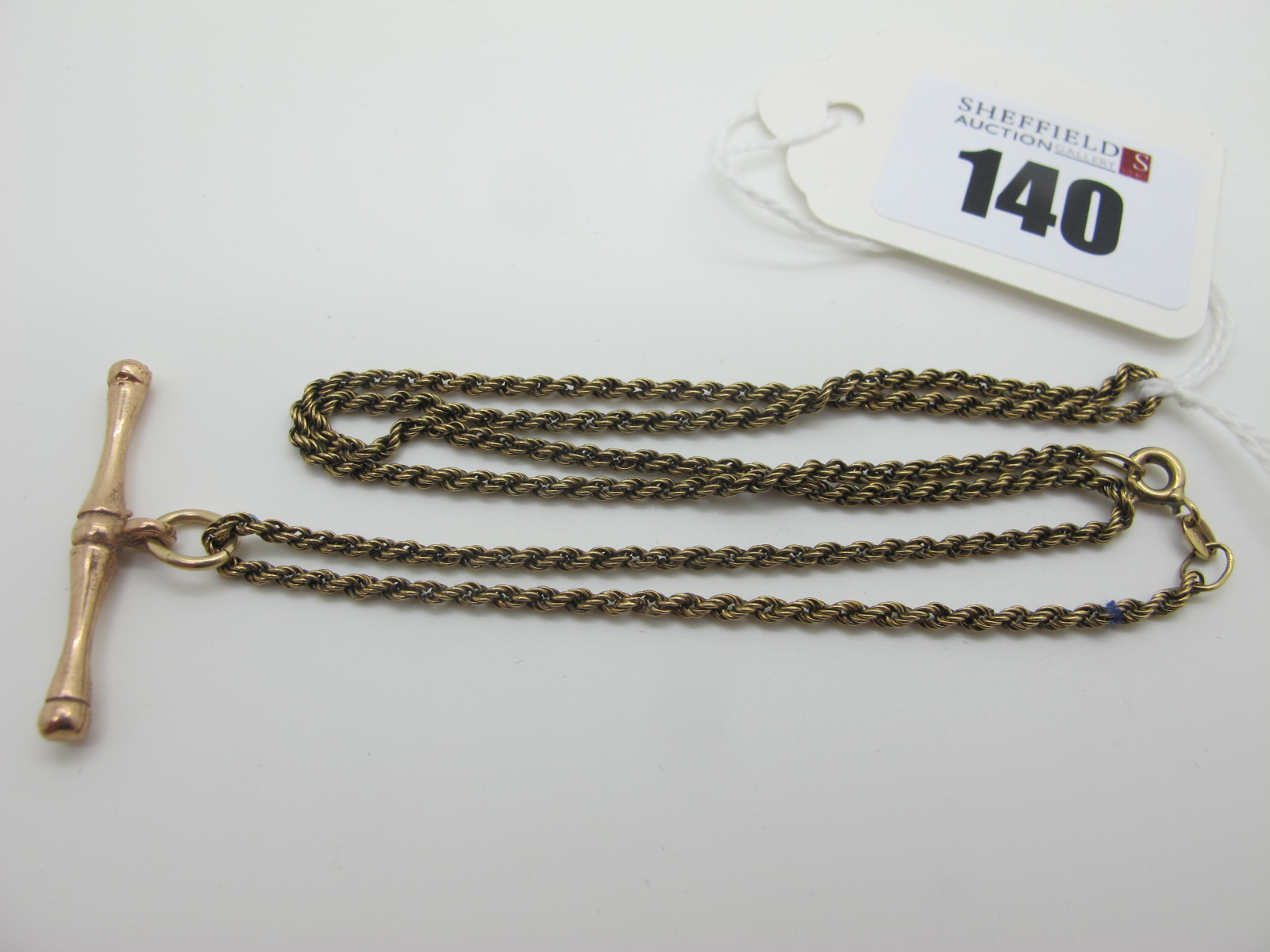 A 9ct Gold Ropetwist Chain, suspending a T-bar pendant.