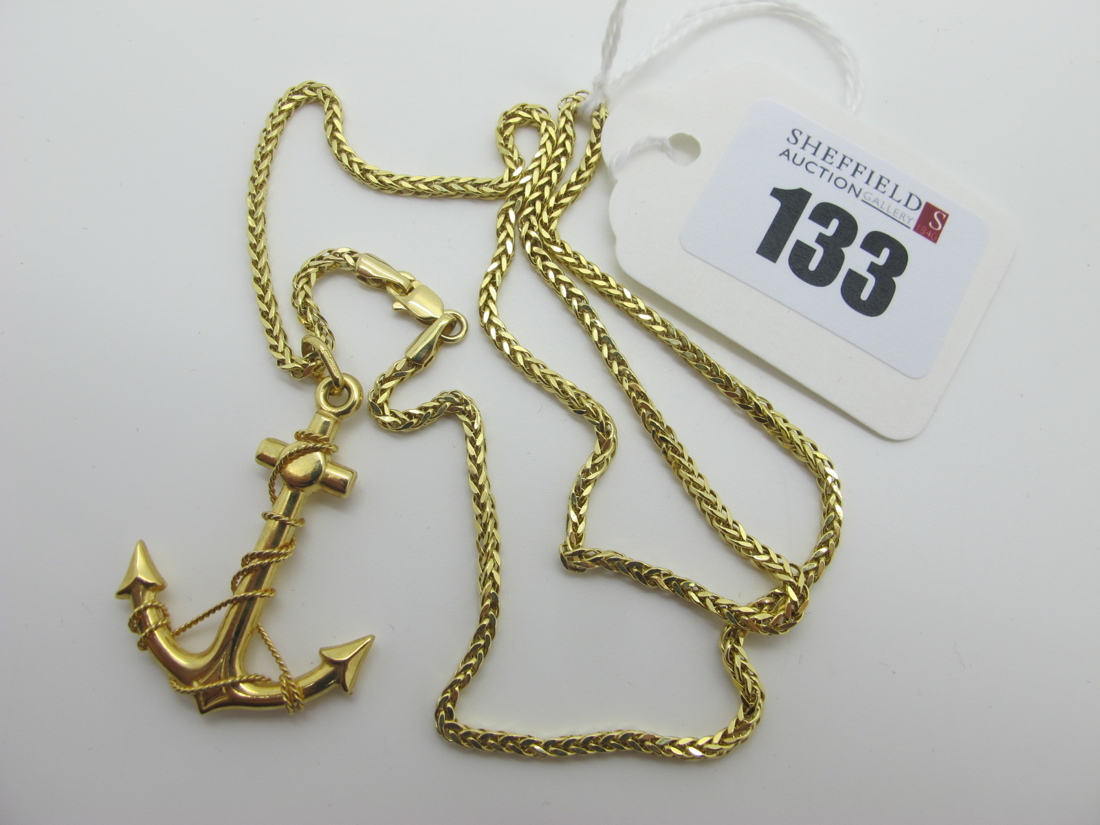 A Modern 9ct Gold Fancy Link Chain, suspending an anchor pendant, stamped "375" (4.7grams).