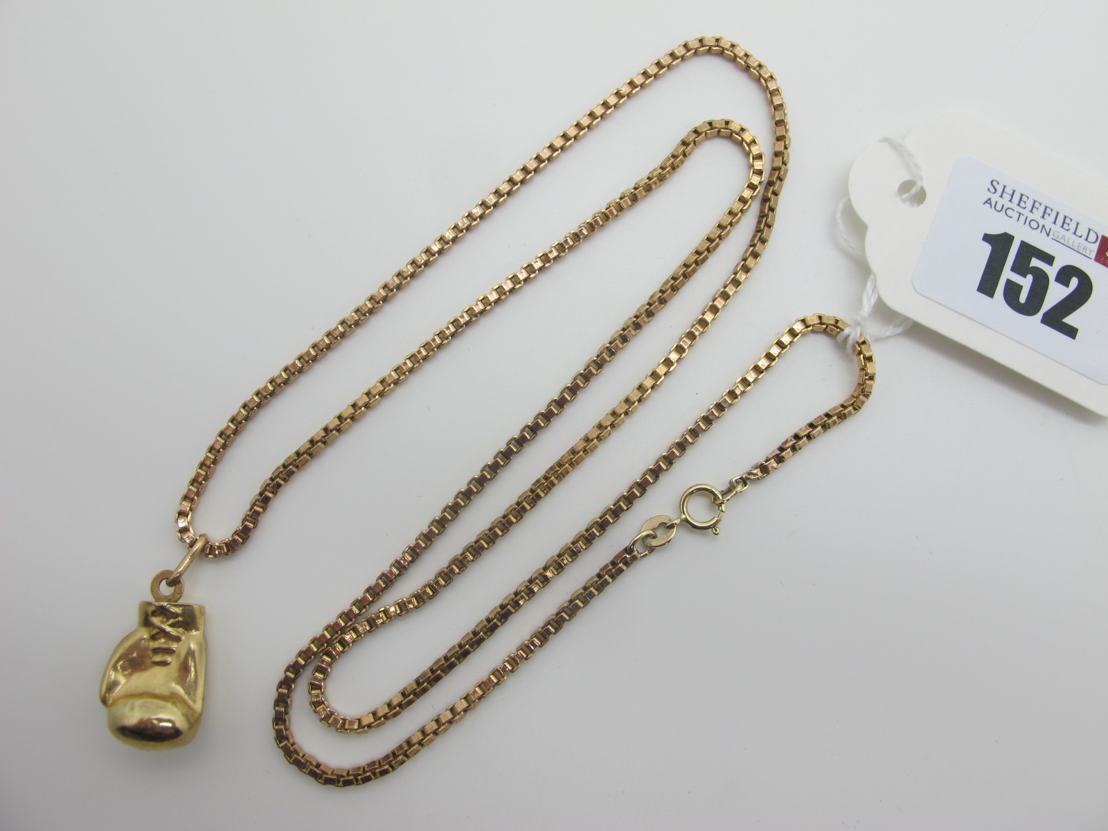 A Box Link Chain, stamped "375", suspending a boxing glove pendant.