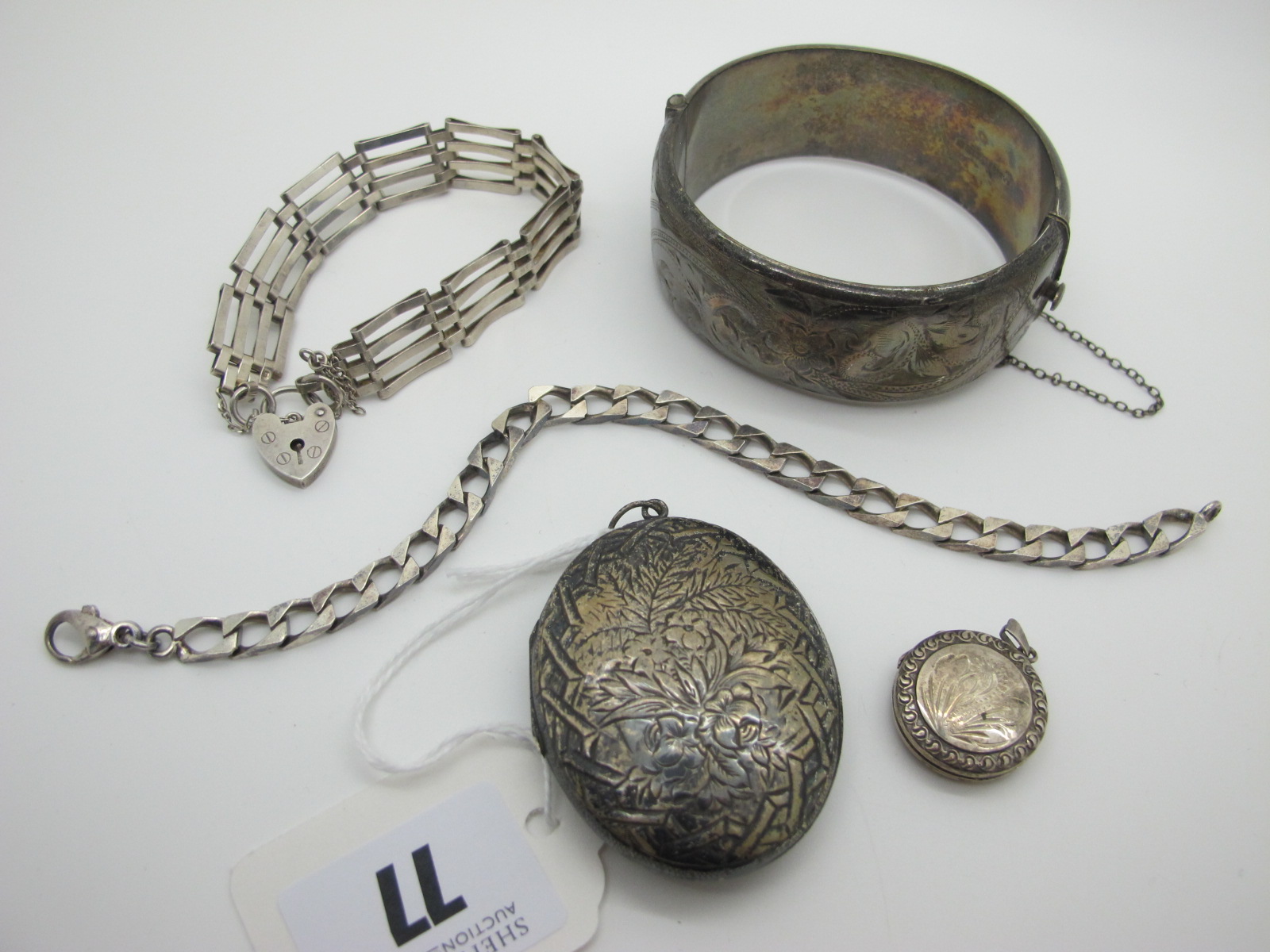 A Wide Hallmarked Silver Bangle, (dents) a large oval locket pendant, foliate engraved, a gate