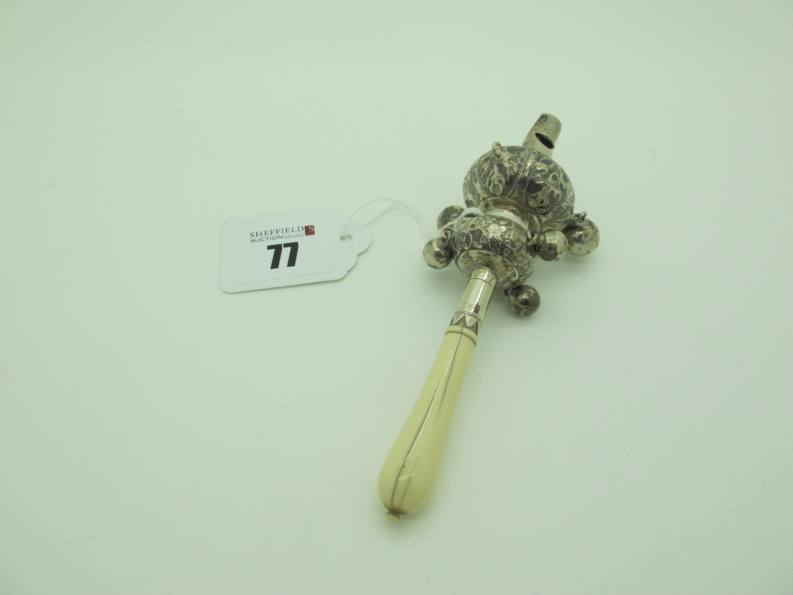 A Decorative XIX Century Ivory Handled Baby's Rattle, with whistle and six bells (one missing) and