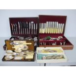A Large Mixed Lot of Assorted Plated Cutlery, including part canteens, in fitted canteen cases