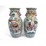 A Pair of Late XIX Century Chinese Pottery Vases, of baluster form with frilled necks and Dogs of Fo