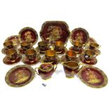 A Carlton Ware Pottery Rouge Royale Tea Service, the maroon grounds decorated in enamels with