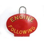 Railwayana; An Oval 'Engine Following' Sign, in red with metal handle, 39 x 53cm.