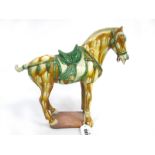 A Chinese Tang Style Horse, painted in typical ochre and green glazes, standing four square on a