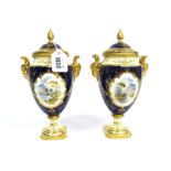 A Pair of Coalport Porcelain Two-Handled Vases and Covers, of ovoid form with rams head handles,