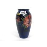 A Moorcroft Pottery Vase, of ovoid form, painted in the Anemone pattern against a dark blue