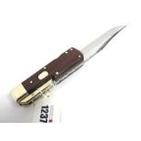 Stan Shaw; A Folding Bowie Knife, with wooden scales, brass bolster and cross guard, workback length