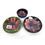 A Small Moorcroft Pottery Bowl, painted in the Anemone pattern against a dark blue ground, impressed
