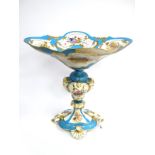 A Modern French Porcelain Centrepiece, the shaped oval bowl raised on fluted baluster stem with rams