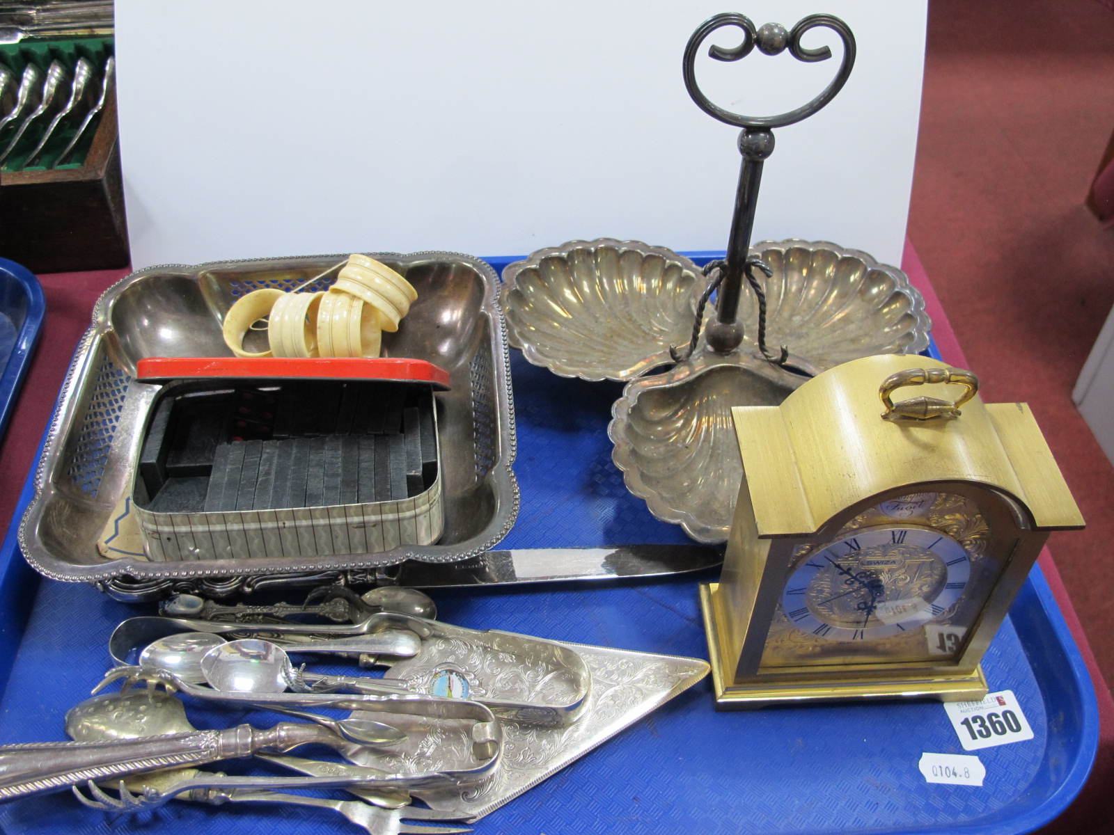 Plated Dish, Cutlery, Swiza gilt mantel clock, etc,. Bone serviette rings, etc:- One Tray.