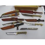 A Quantity of Asian Style Bowie Knives, all with sheaths, with ornate brass handles, some jeweled,