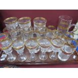 A Suite of Bohemian Gilt Rimmed and Engraved Glassware, including jug and six tumblers, six tall