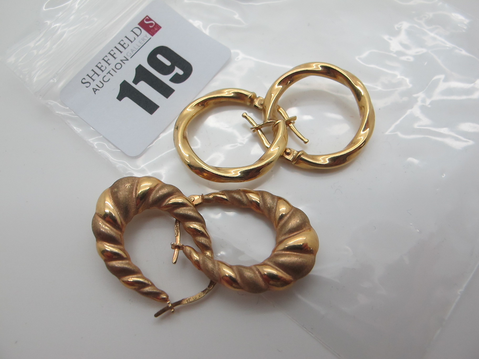 Two Pairs of Modern Hoop Earrings, stamped "375" (3.5grams). (2)