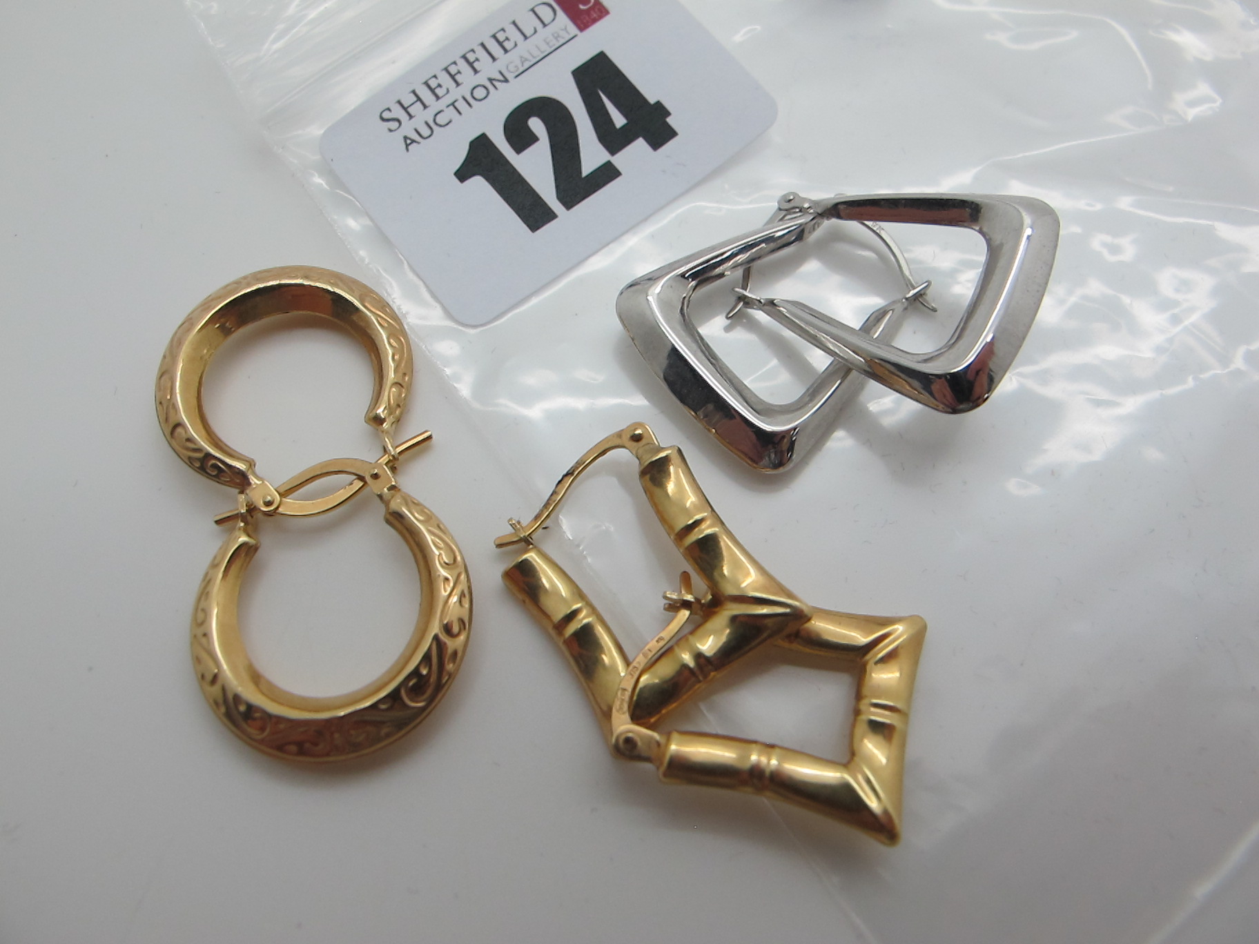 Two Pairs of Modern Hoop Earrings, stamped "375"; together with another pair of earrings. (3)