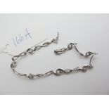 Scrap - A Modern White Openwork Bracelet, stamped "375" (damages / lacking stones) (4.8grams).