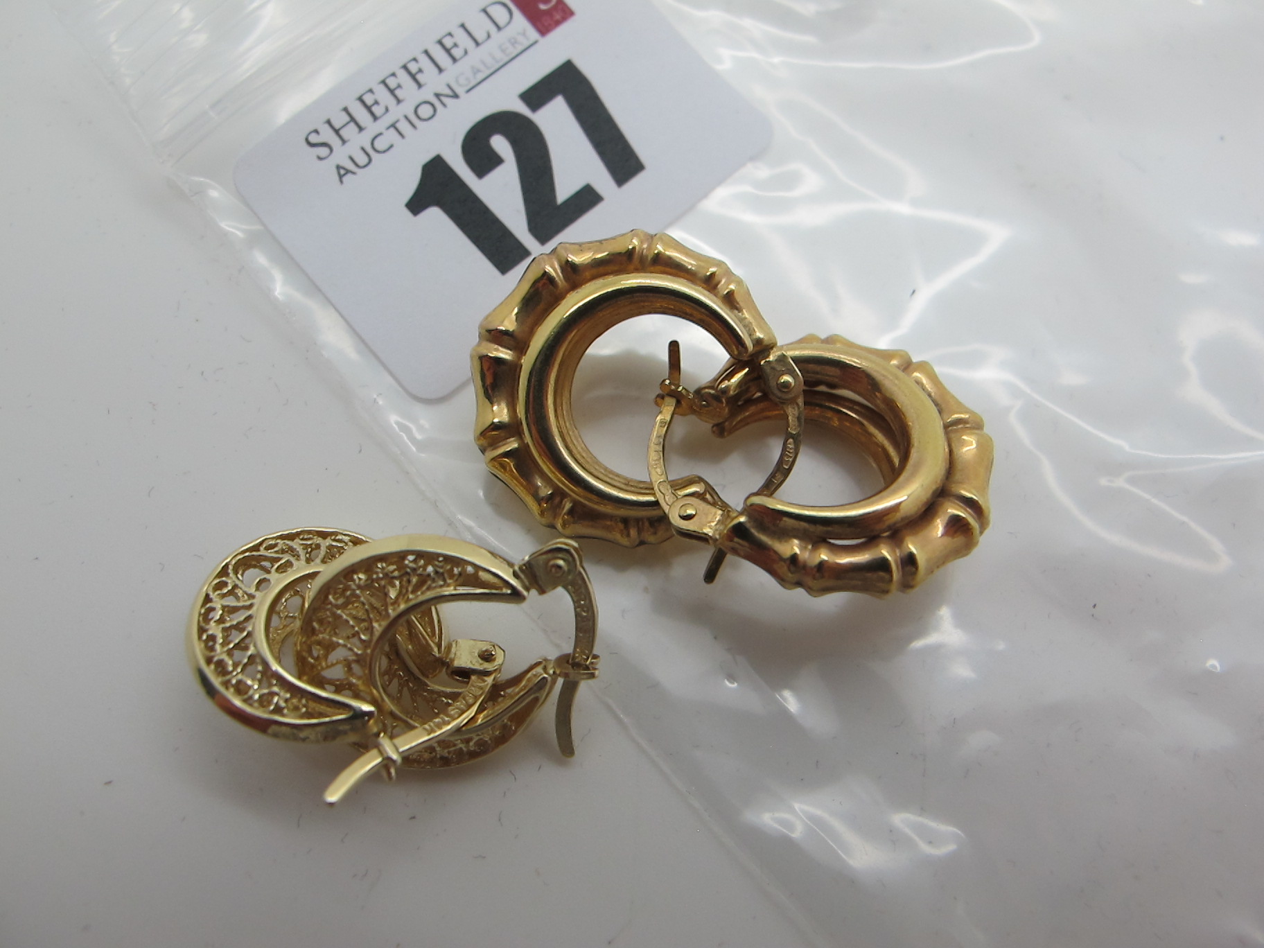 A Pair of Modern Earrings, stamped "375"; together with a smaller pair of earrings, stamped "14k".