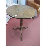 An XVIII Century Oak Pedestal Table, the circular top with unusual single drawer, on turned pedestal