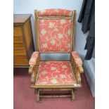 An Early XX Century Oak America Rocking Chair, with upholstered back, arms, seat, turned spindles,