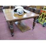 An Early XX Century Wind Out Walnut Dining Table, top with a moulded edge on turned and reeded legs,