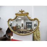 An Edwardian Gilt Framed Bevelled Wall Mirror, with scroll shoulders and vase cresting, 87cm wide.