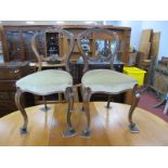 A Pair of XIX Century Walnut Chairs, with carved top rails and scroll centre rail, upholsted seats,