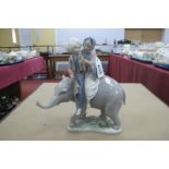 A Lladro Figure Group 'Hindu Children on an Elephant', 23cm high.