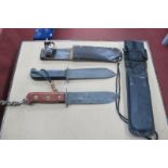 Military Survival Knives (x 2), 2001 - 1993, in sheaths. (2)