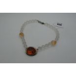 A Modern Designer Style Necklace, composed of uniform frosted beads, with central hallmarked