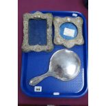 A Hallmarked Silver Backed Hand Mirror, together with two hallmarked silver photograph frames (