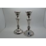 A Pair of Hallmarked Silver Candlesticks, B&Co, Birmingham 1969, with reeded detail on circular