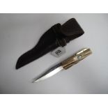 Stan Shaw; A Folding Bowie Knife, with stag scales, brass crosspiece, workback to spring and back of