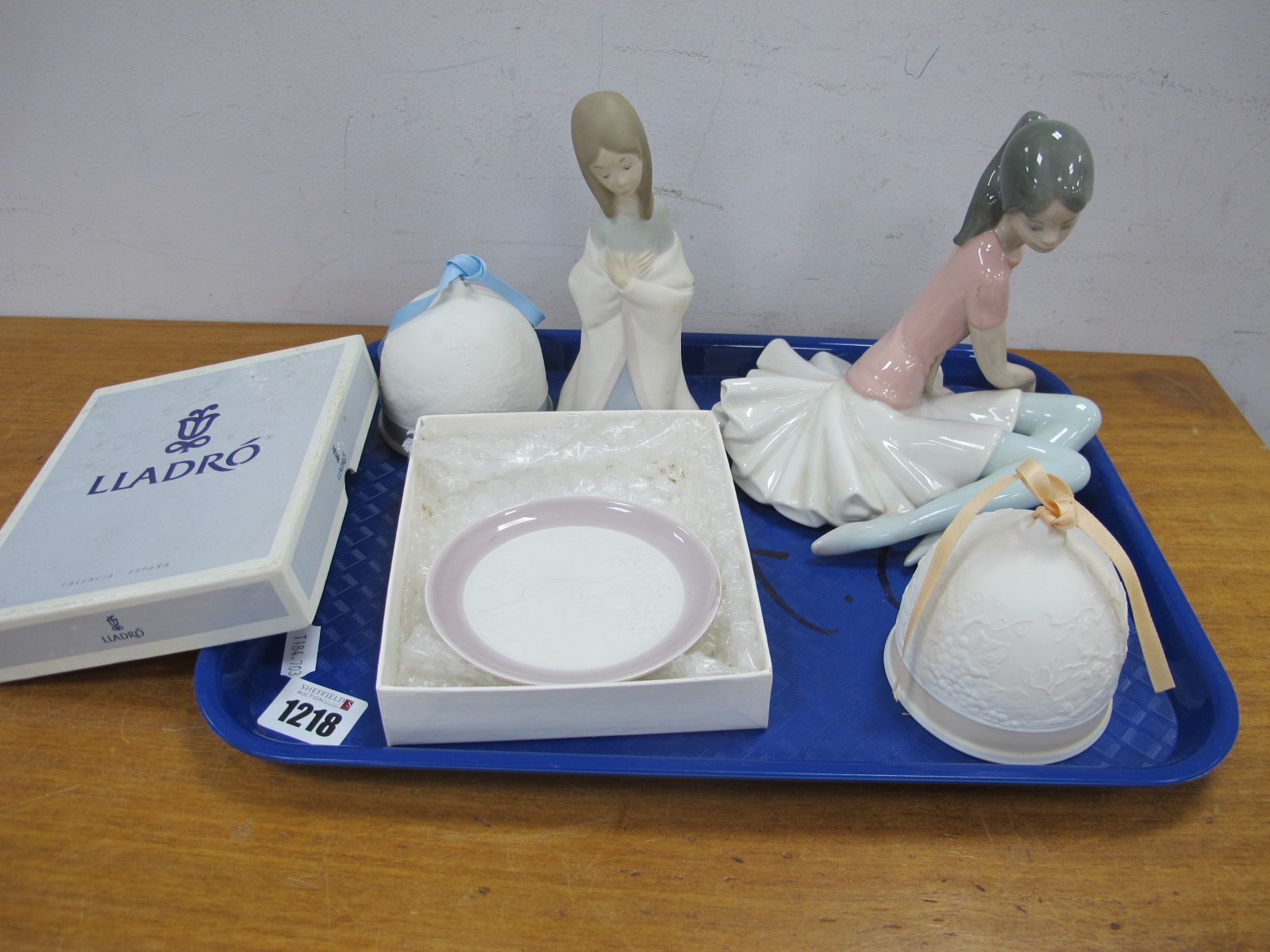 A Lladro Seated Ballerina, 14.5cm high, praying child, 1993 and 1994 bells, apple picker pin tray.