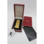 Cartier; A Gold Plated Lighter, allover textured finish, stamped "Cartier Paris" and numbered "