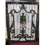 A Leaded Glass Panel Inset with Polished Glass Stones, featuring vase on cream ground with green