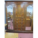An Edwardian Inlaid Mahogany Triple Wardrobe, with stepped pediment, mirror doors, to hanging