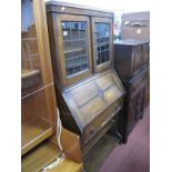 A 1920's Oak Bureau Bookcase, top with leaded glazed doors, fall front, fitted interior, single