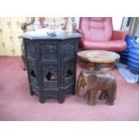 An Indian Ebonized Octagonal Topped Coffee Table, with pierced figural folding base, 51.5cm wide.