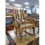 XIX Century Rocking Chair, with shaped central splat, curved hand rests, turned legs.