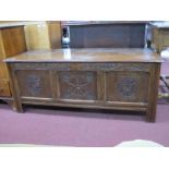 An Oak Blanket Chest, circa 1900, with carving of thistles to top bar, over three symmetrical