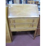 An Oak Bureau, circa 1930's with fall front, fitted interior, over two drawers on tapering legs,