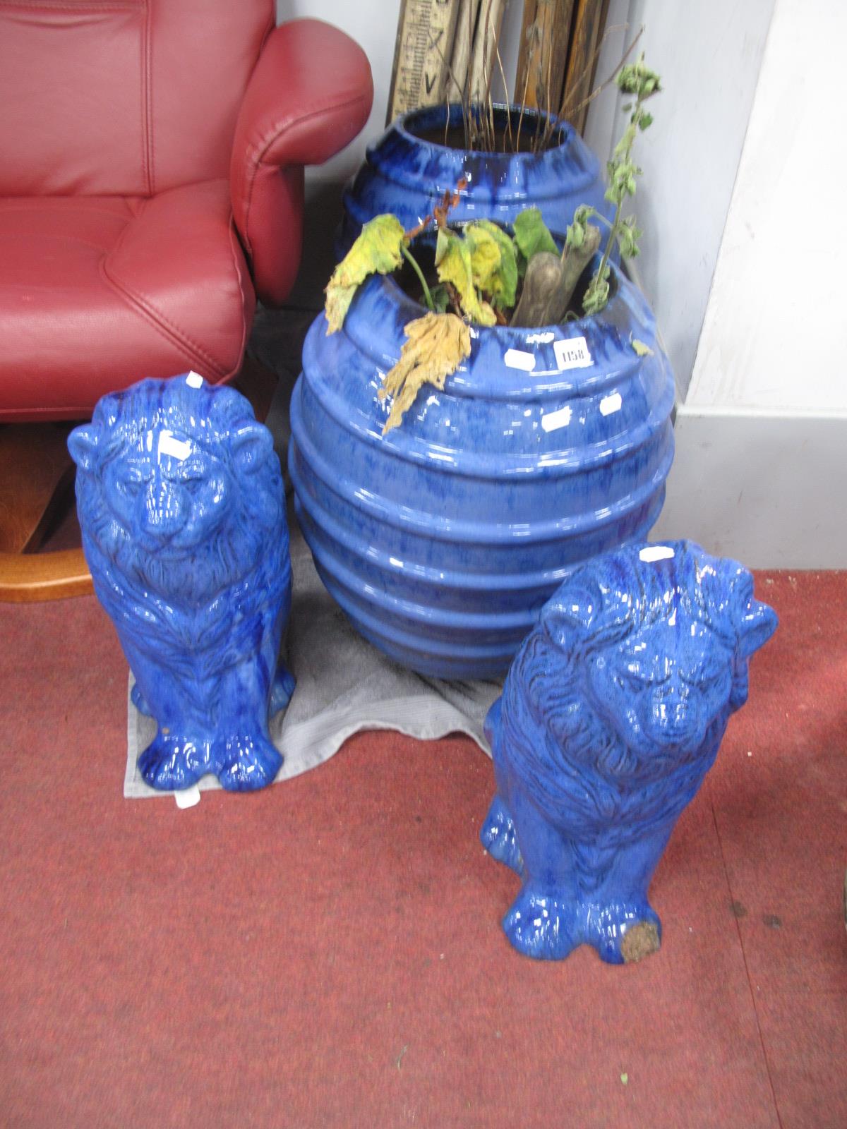 A Pair of Blue Glazed Terracotta Barrel Shape Planters, 48cm high, pair of similar lions. (4).