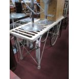 A Metal Operating Table, circa early to mid XX Century, white painted, on two wheels.